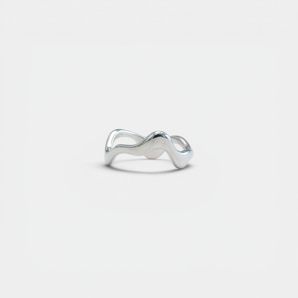 Nooe UG asymmetric sterling silver ring with a fluid, melting metal design. Polished silver.