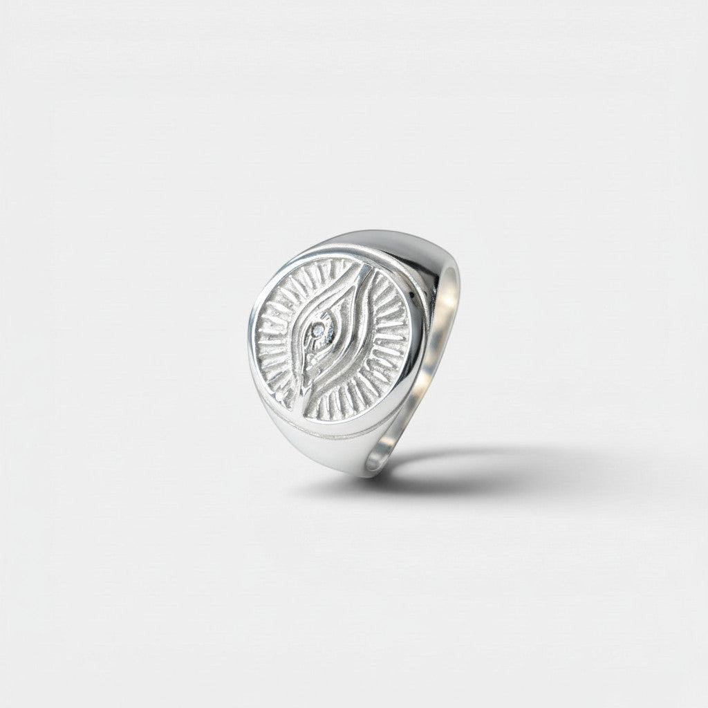 Nooe UG sterling silver Horus eye signet ring with sunburst detail and small central diamond. Unisex design.