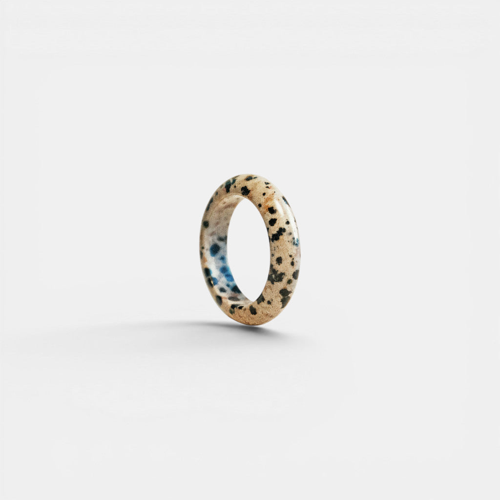 Nooe Berlin oval Dalmatian Jasper ring, a unique natural stone with black spots and blue accents, polished finish.