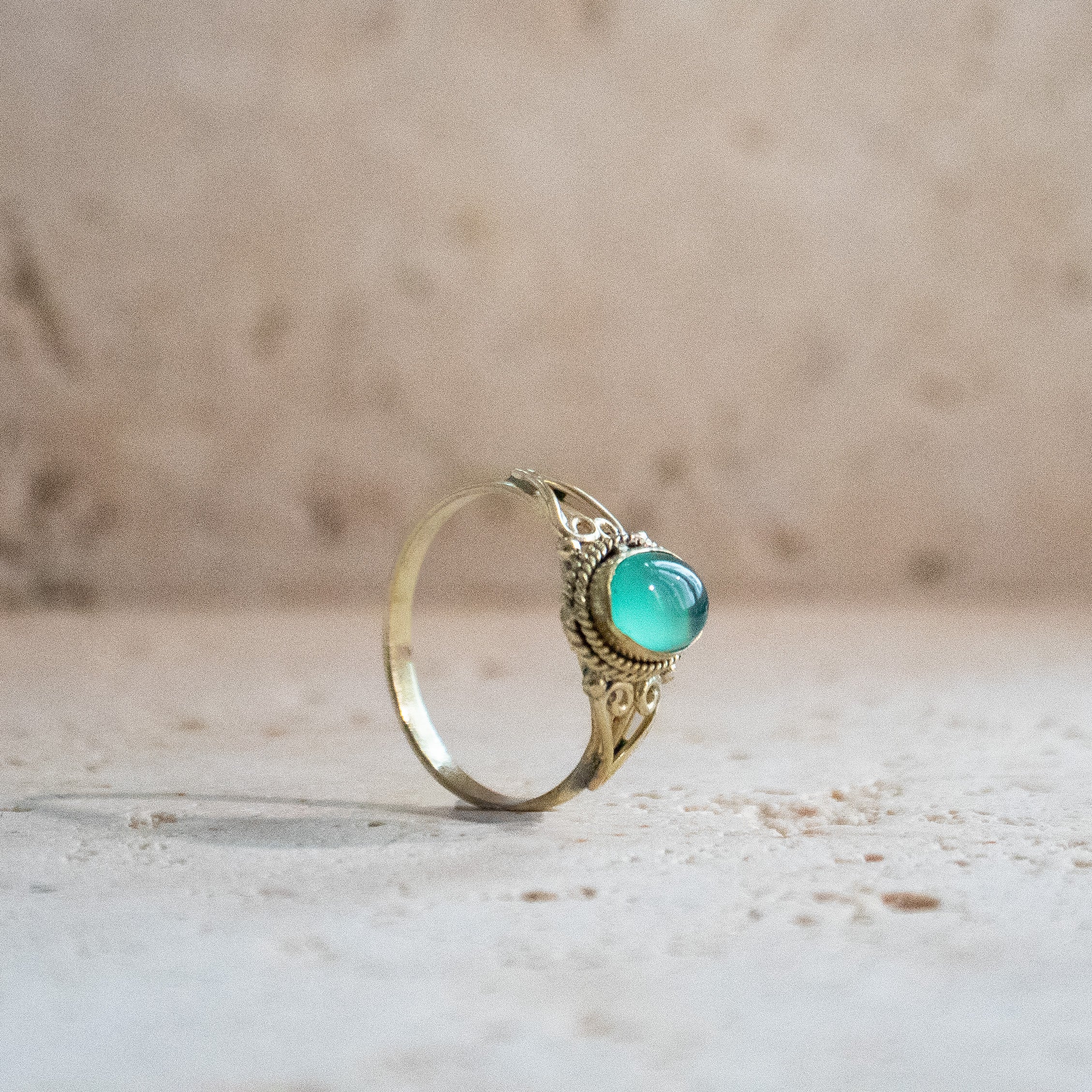 Green onyx ring with oval stone playfully handmade in gold
