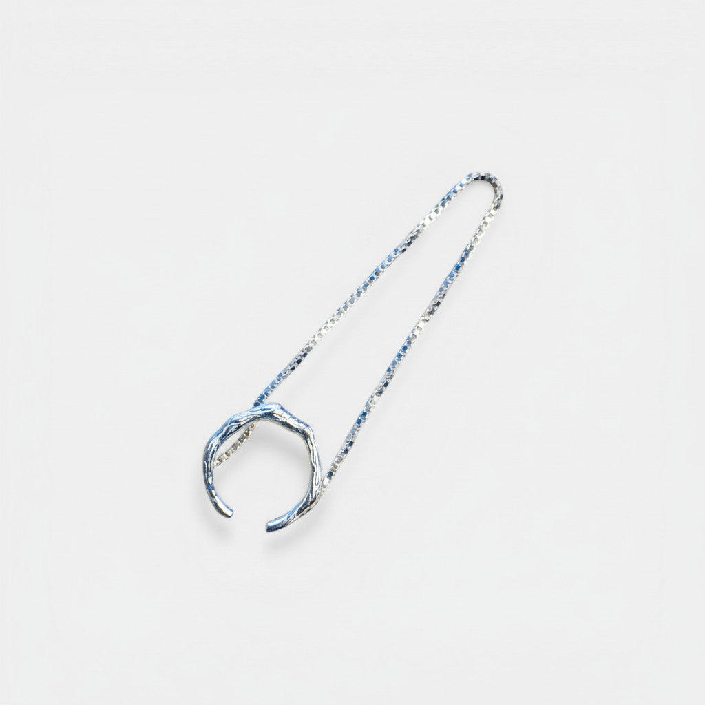 Nooe Berlin asymmetric ear cuff with chain, made of 925 sterling silver with an organic, textured design.