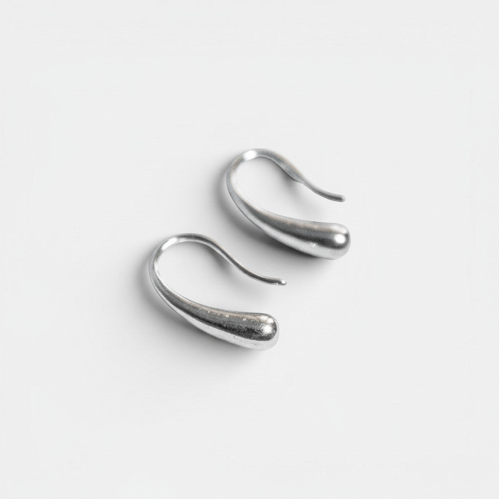 Nooe Berlin organic sculptural earrings in polished 925 sterling silver with a teardrop shape.